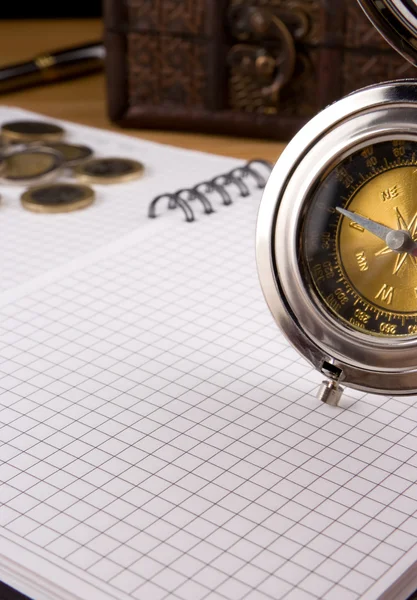 Kompas srebrne, monety i notebooków — Zdjęcie stockowe