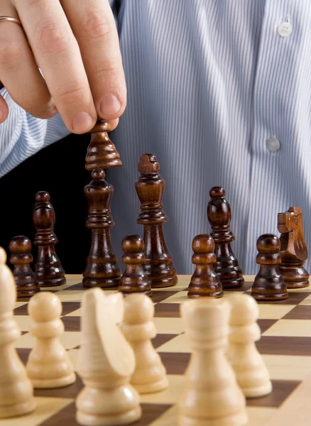Hand moving chess piece — Stock Photo, Image