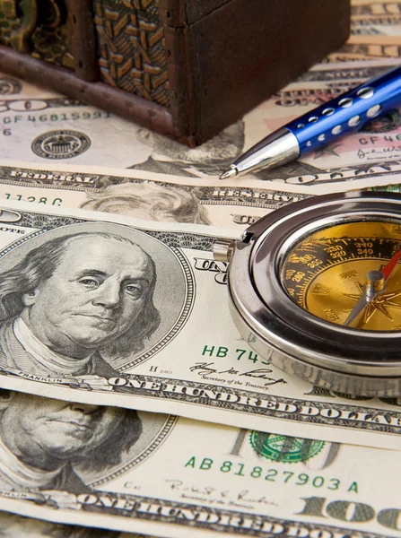 Pen and old compass on dollars — Stock Photo, Image