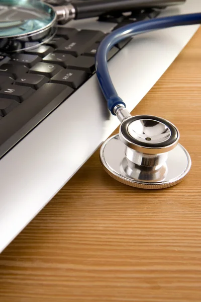 stock image Stethoscope and magnifying glass on keyboard