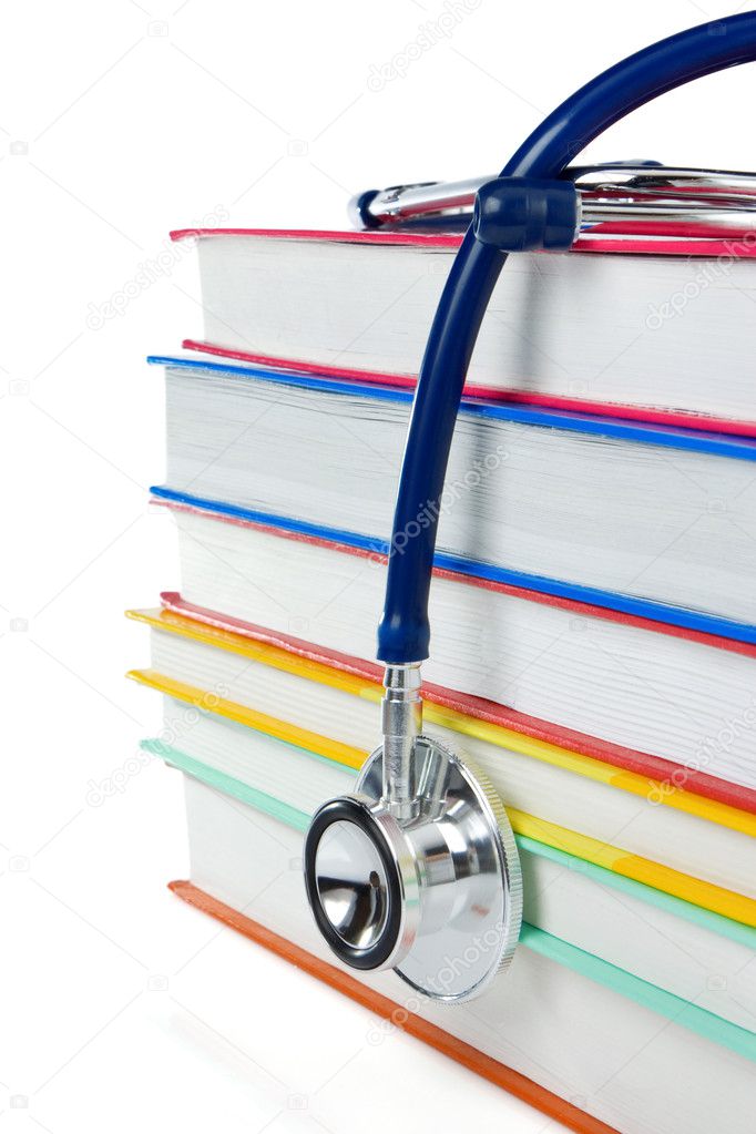 Pile of books and stethoscope isolated on white