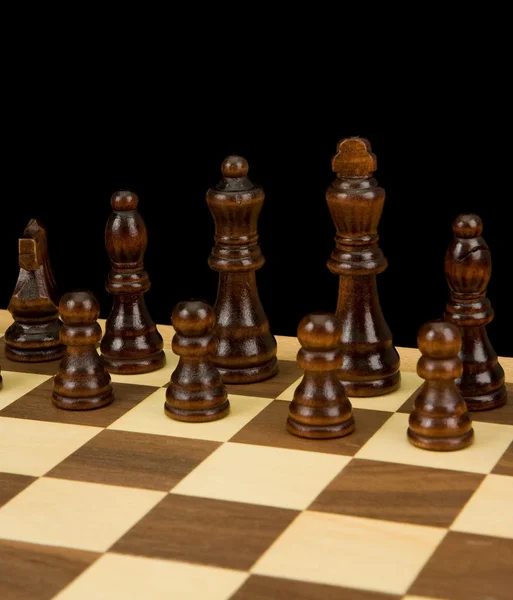 Chess piece on board isolated on black — Stock Photo, Image