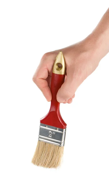 Mão masculina e escova vermelha no branco — Fotografia de Stock