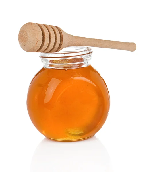 Glass pot full of honey on white — Stock Photo, Image