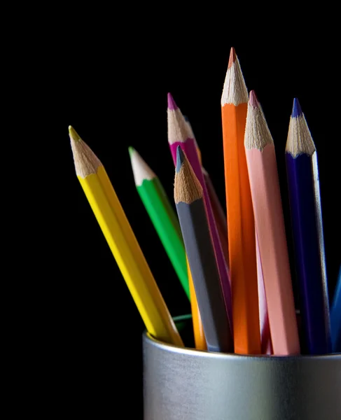 Holder basket full of pencils on black — Stock Photo, Image