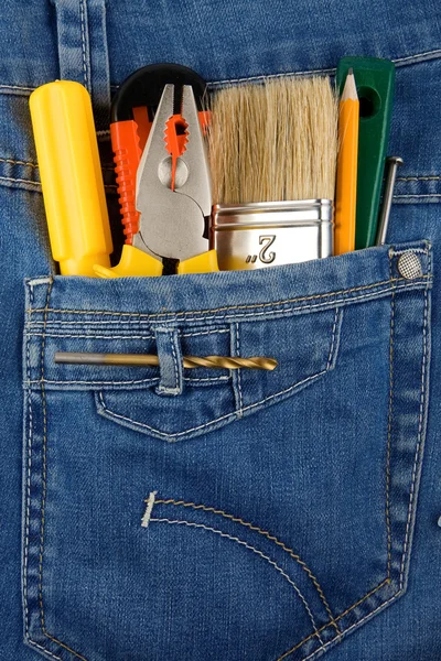 Tools and instruments in jeans — Stock Photo, Image