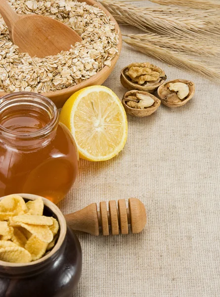 Oat, honey and healthy food on sacking — Stock Photo, Image