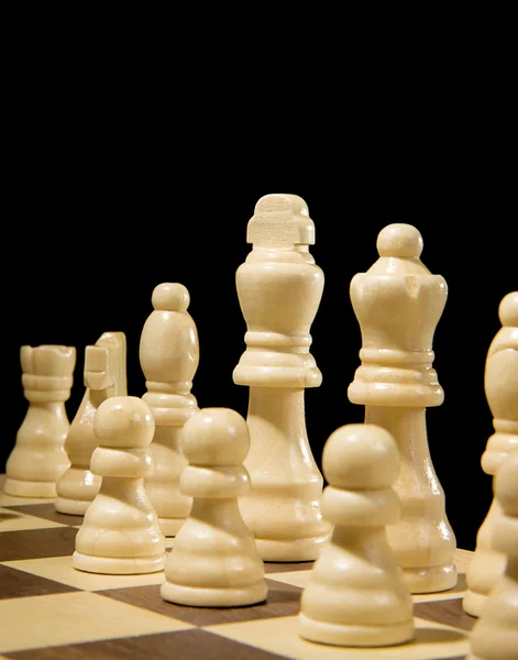 Chess piece on board isolated on black — Stock Photo, Image