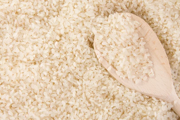 Łyżka ryżu tło i drewna — Zdjęcie stockowe