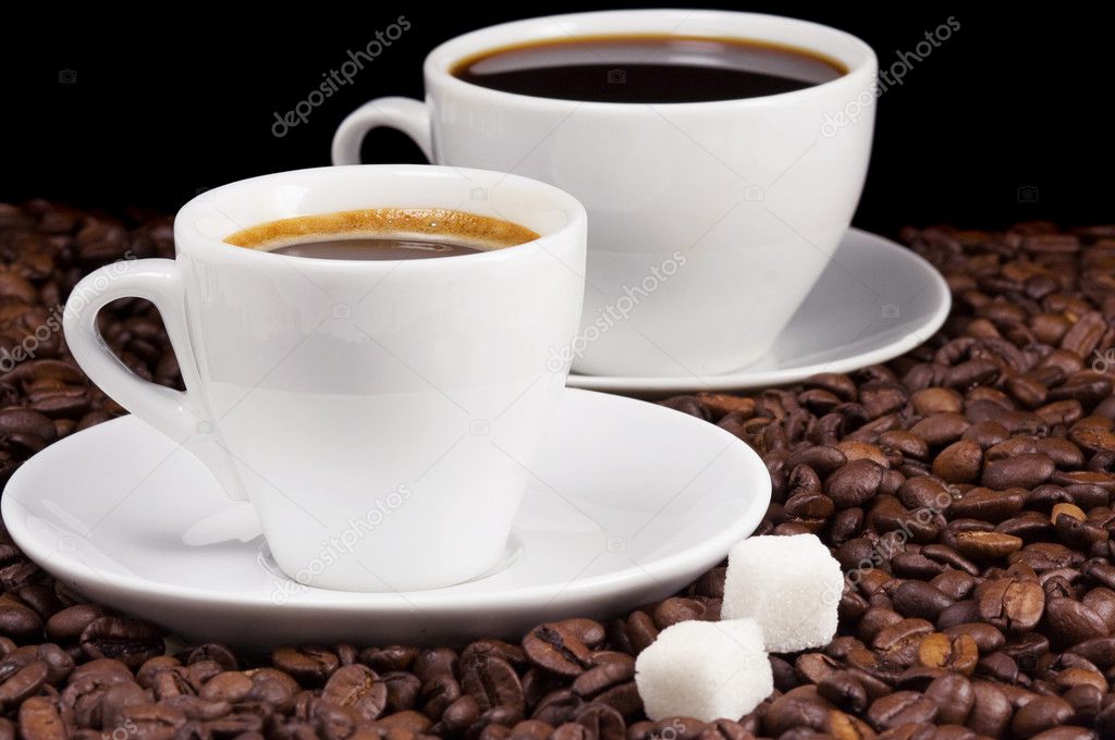 White cups of coffee on beans