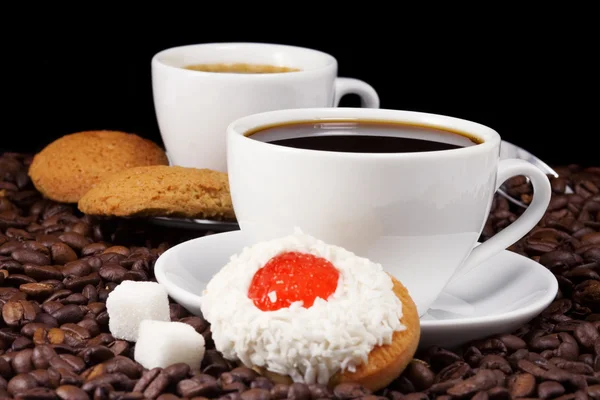 Coffee and cookies on beans — Stock Photo, Image