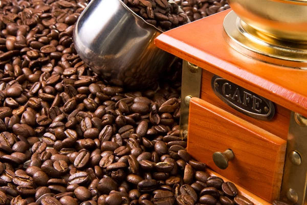 Grãos de café, panela e moedor de madeira — Fotografia de Stock