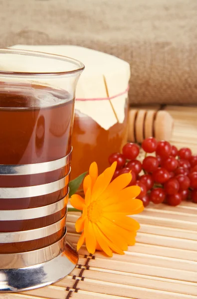 Tea with flower, honey, viburnum and sack — Stock Photo, Image