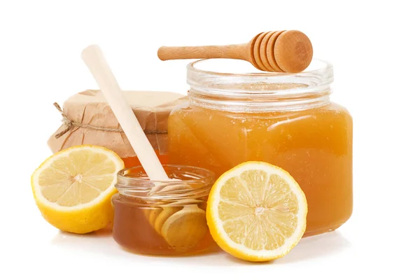 Pot of honey and sliced lemon — Stock Photo, Image