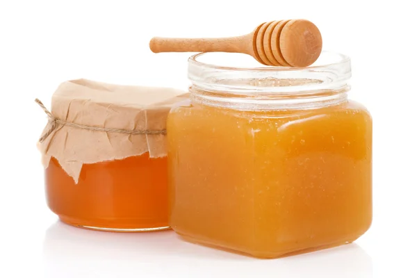 Solated glass jars of honey on white — Stock Photo, Image