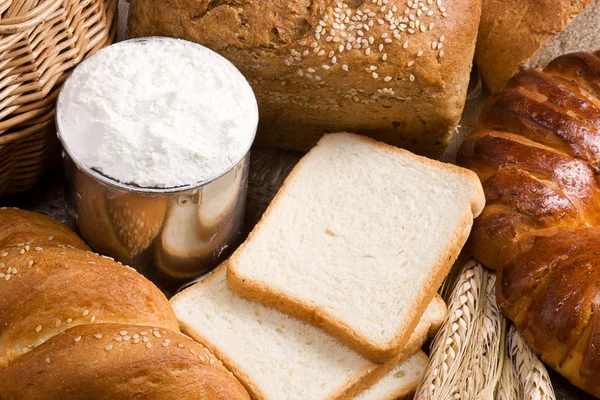 Bread, spike, flour and basket — Stock Photo, Image