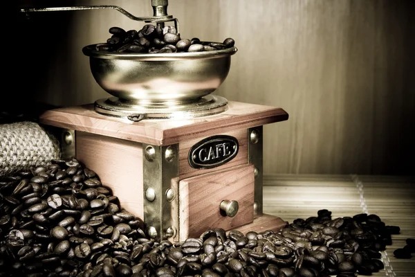 Coffee grinder, beans and pot on sacking — Stock Photo, Image