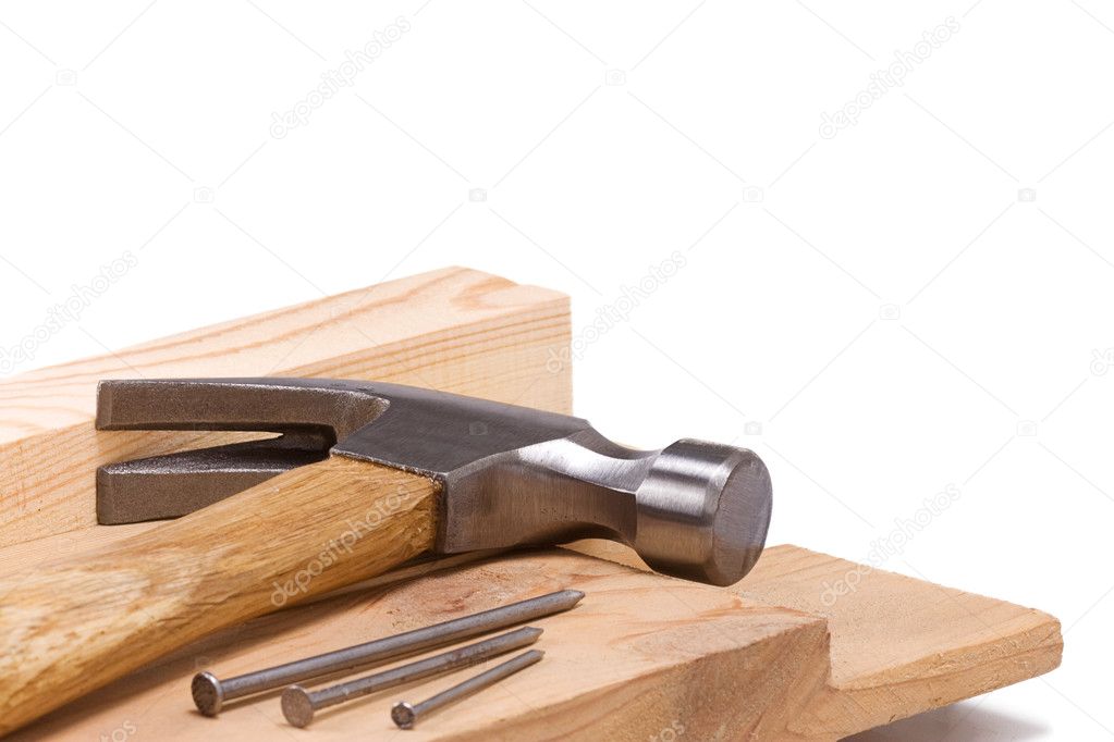 Hammer and nail isolated on wood