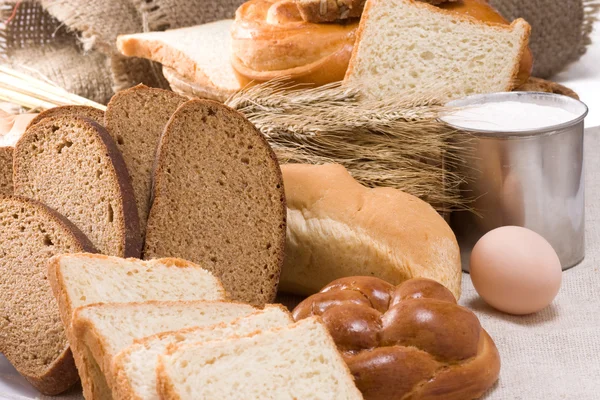 Bakery products and basket on sack — Stock Photo, Image