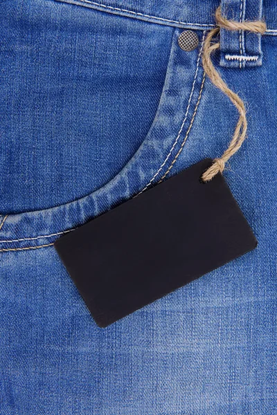 Precio tag over jeans textured pocket —  Fotos de Stock