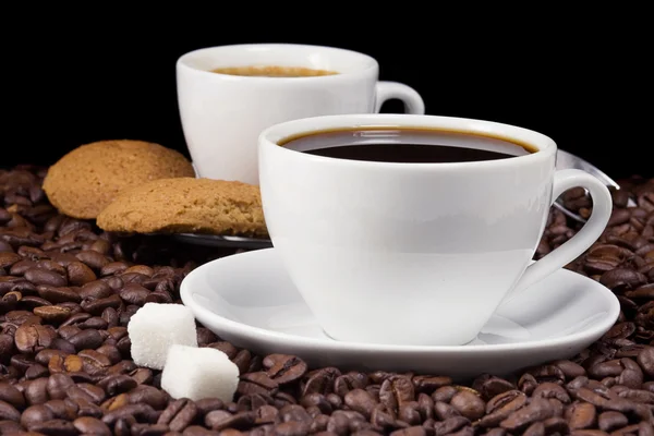 Cup of coffee and cookies on beans — Stock Photo, Image