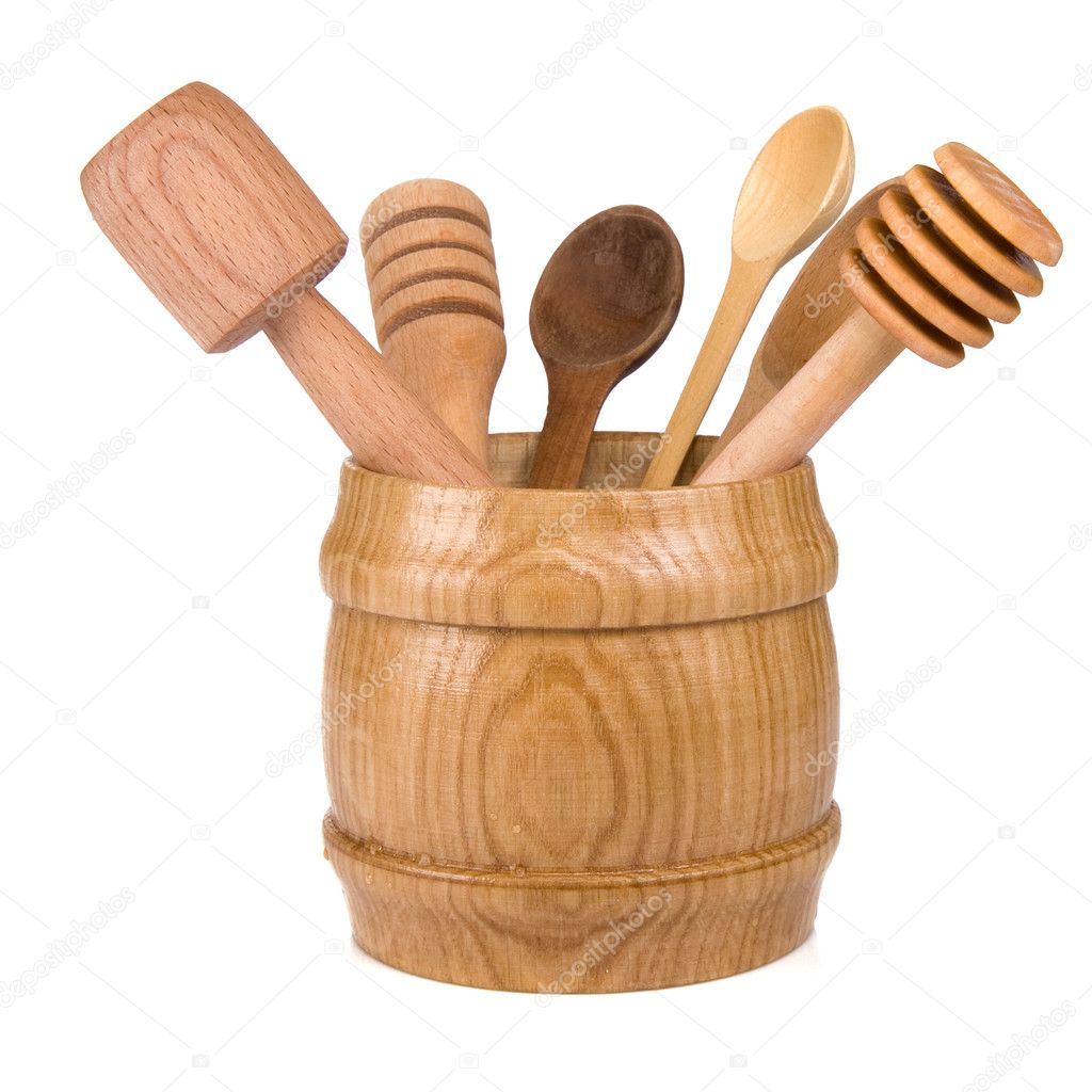 Wooden cooking utensils in container isolated on white — Stock Photo