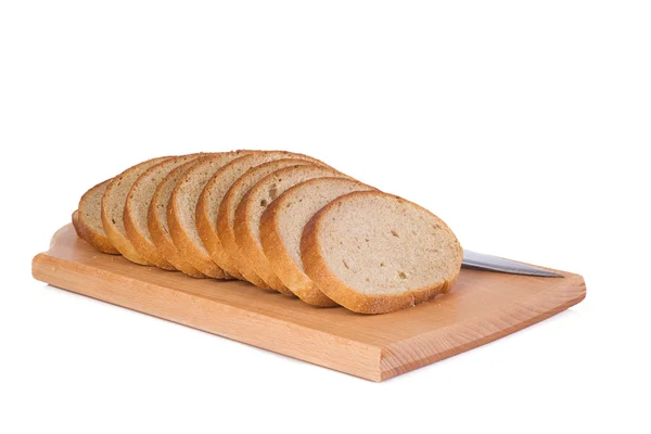 Knife and bread at board — Stock Photo, Image