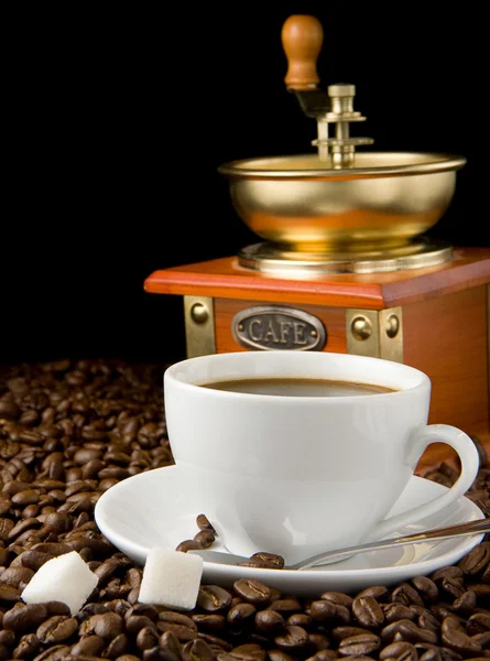 Cup of coffee, beans and grinder — Stock Photo, Image
