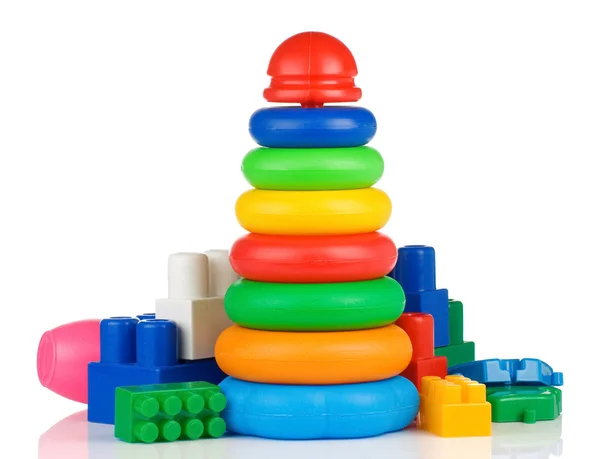 Brinquedos de plástico coloridos e tijolos em branco — Fotografia de Stock
