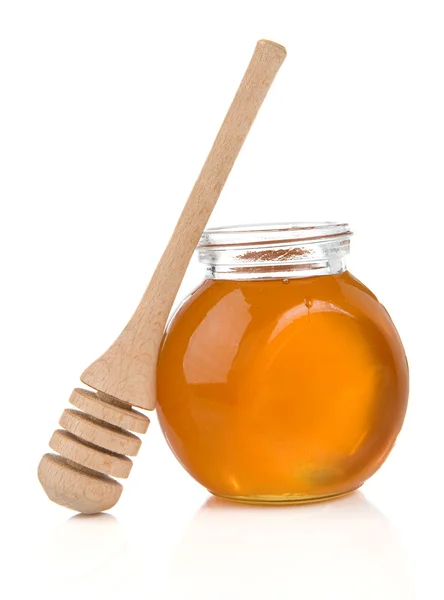 Pot of honey and stick on white — Stock Photo, Image