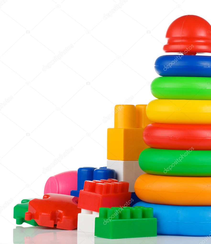 Colorful plastic toys and bricks on white