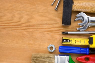 Tools on wood board background clipart