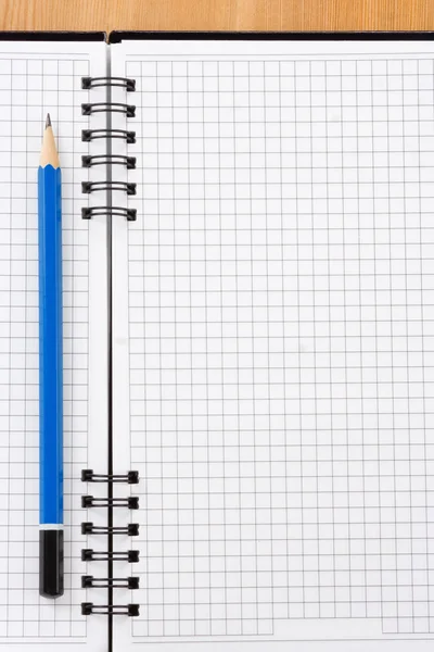 Pencil on checked notebook Stock Photo