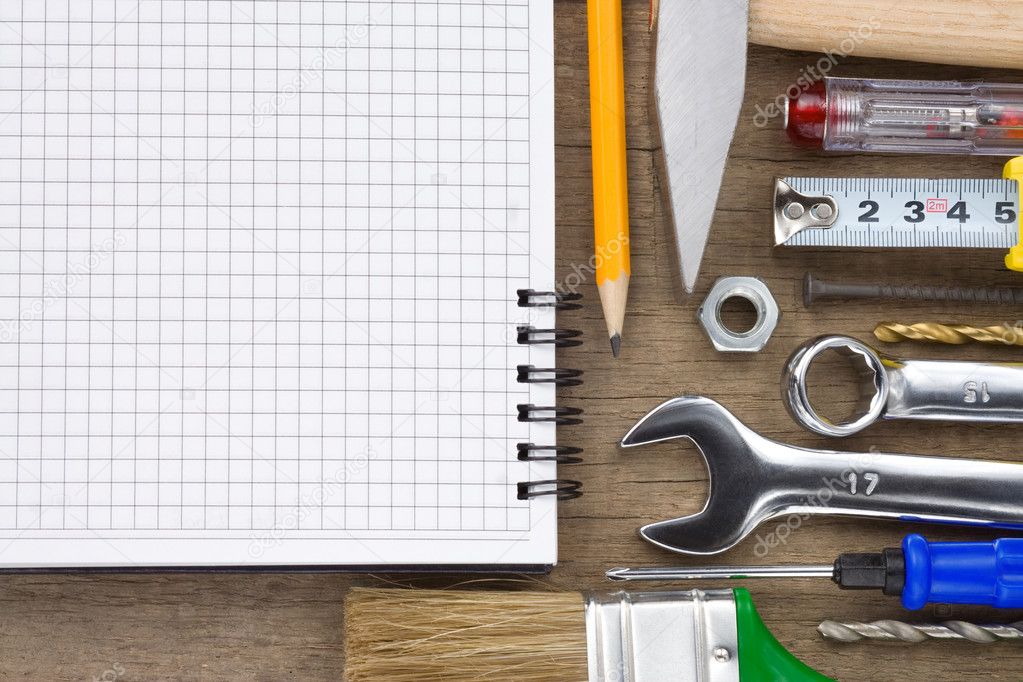 Set of tools and notebook on wood