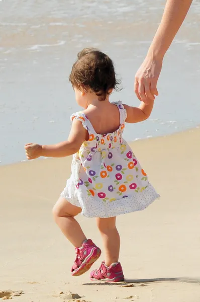 Bebê menina caminha em uma praia — Fotografia de Stock