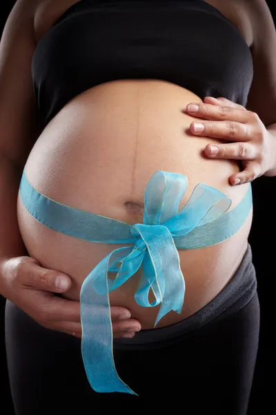 Pregnancy and blue ribbon — Stock Photo, Image