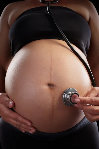 Pregnancy and stethoscope — Stock Photo, Image