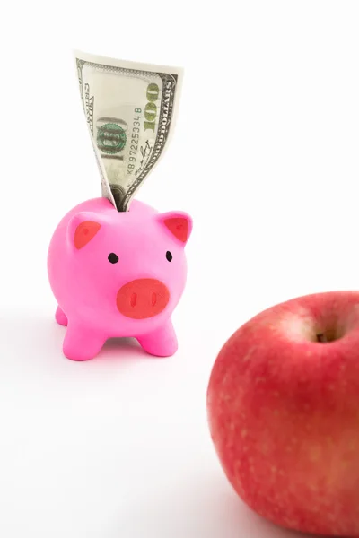 Kumbara, dolar ve elma — Stok fotoğraf