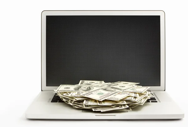 Stapel dollarbiljetten op laptop — Stockfoto