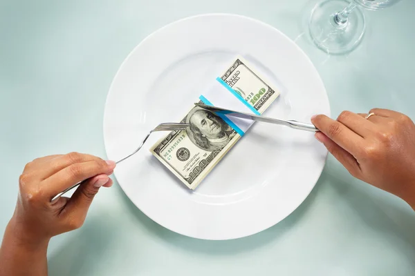 Eating the dollar bills — Stock Photo, Image