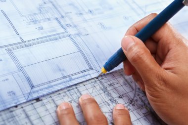 Architect working on house deisgn clipart