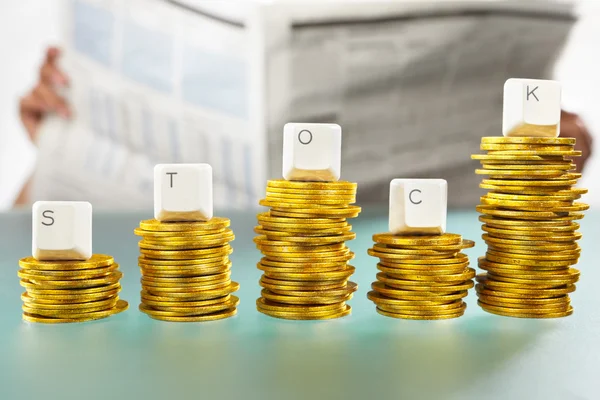 STOCK word on graph like coin stacks — Stock Photo, Image