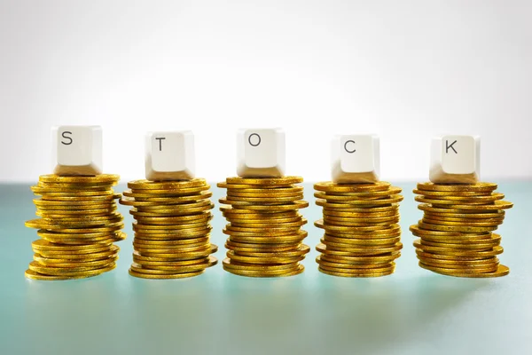 STOCK letter on gold coins stack — Stock Photo, Image
