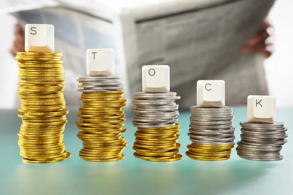 STOCK word on graph like coin stacks — Stock Photo, Image