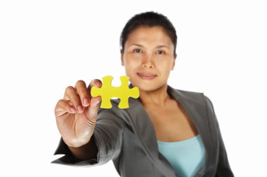 Businesswoman showing jigzaw puzzle piece clipart