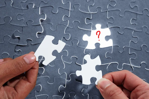 stock image Choosing the right piece of puzzle