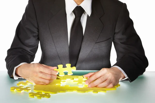 Businessman trying to finish the puzzle — Stock Photo, Image
