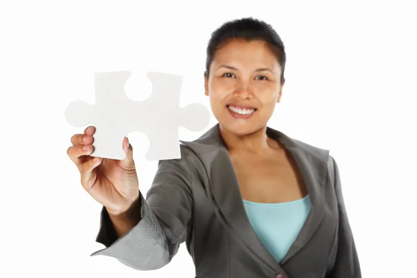Businesswoman showing jigzaw puzzle piece — Stock Photo, Image