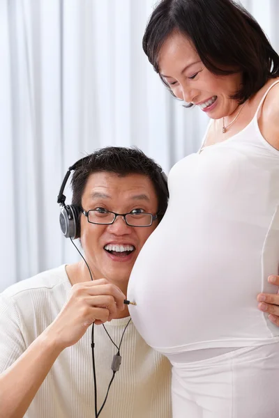 Concept of husband trying to hear fetus sound — Stock Photo, Image