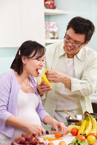 Asian couple activity in kitchen — Stock Photo, Image